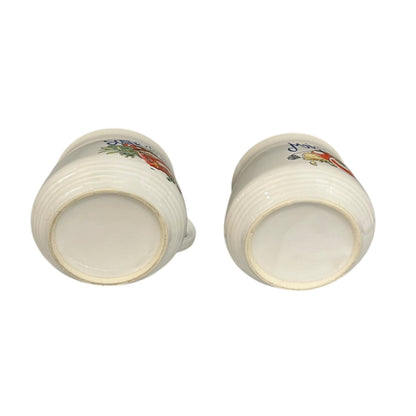 Two ceramic cups with floral patterns on a white background