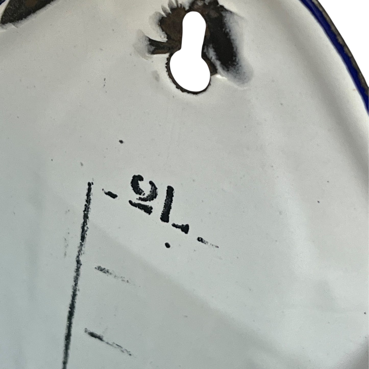 Close up of  French vintage enamel planter with a flat back and a spout on a white background