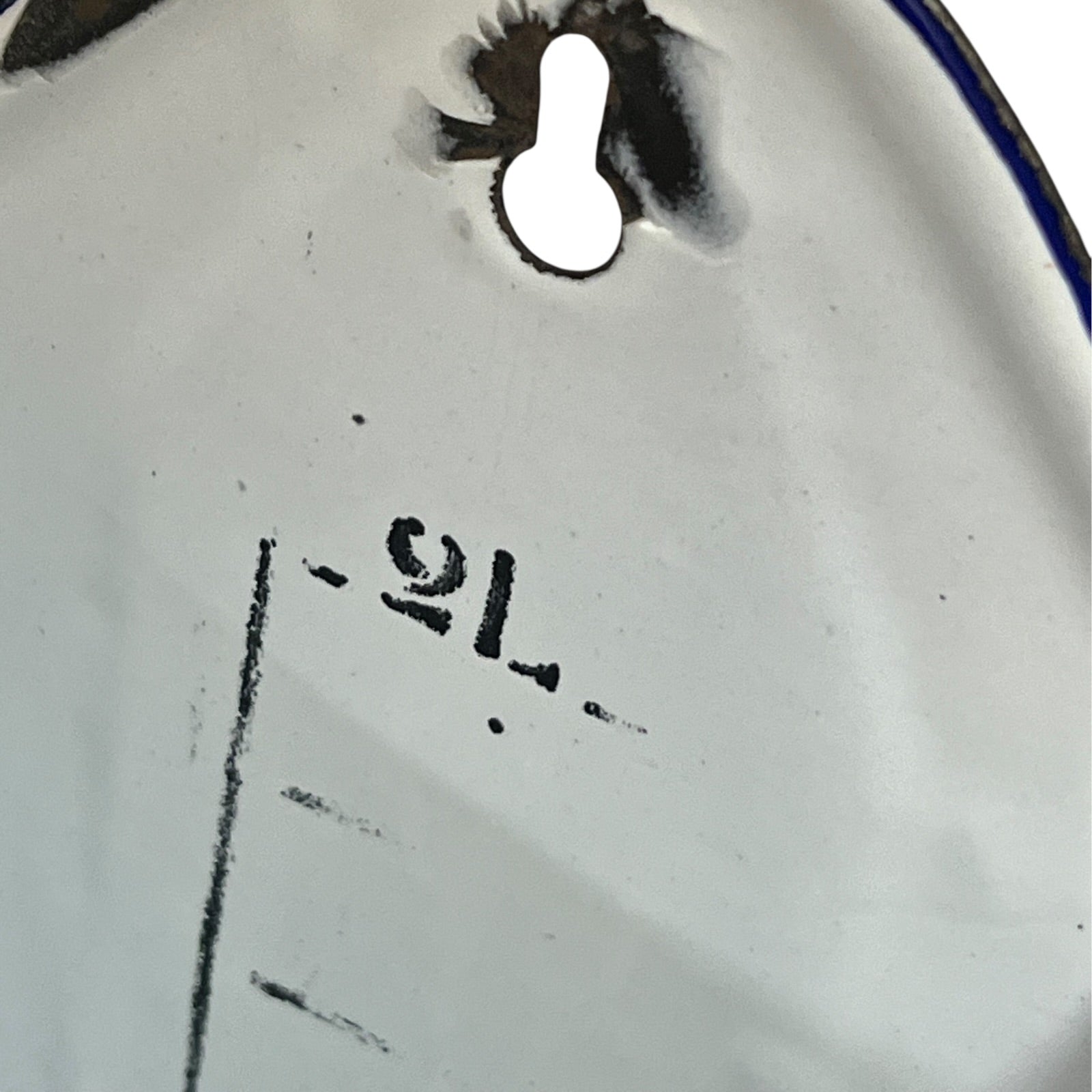 Close up of  French vintage enamel planter with a flat back and a spout on a white background