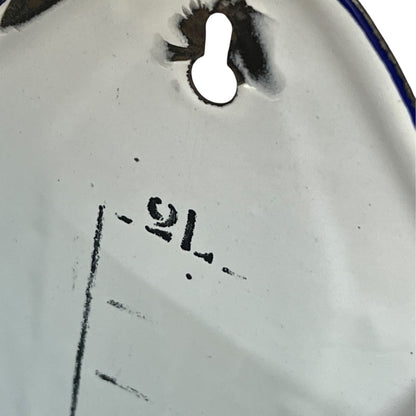 Close up of  French vintage enamel planter with a flat back and a spout on a white background