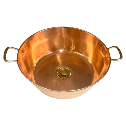 Copper sink with brass handles on a white background