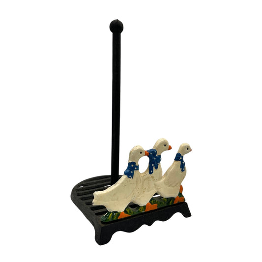 Decorative towel holder with three goose figures on a white background
