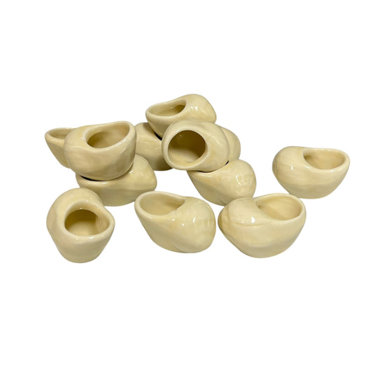 Set of 12 ceramic French escargot cups shaped like snails ideal for a restaurant or a keen French cook, set on a white background