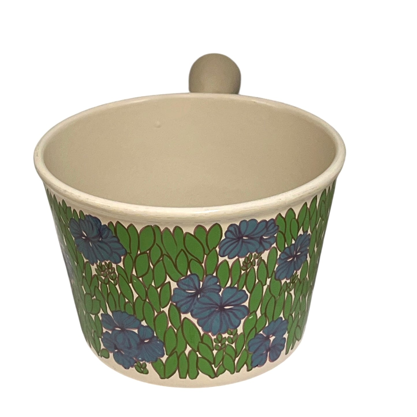 Vintage Le Creuset cast iron fondue pan in rare 1970s floral design, with blue flowers and green leaves, styled on a white background Shown from the front 