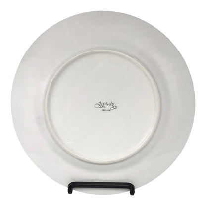 White ceramic plate with a visible brand logo on a white background