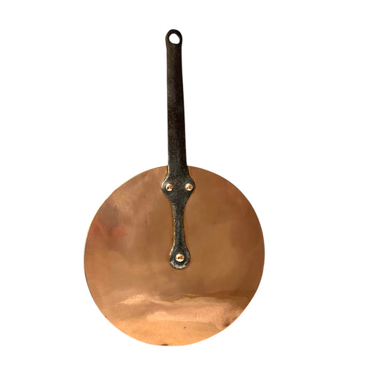 French vintage copper pan lid with new tin lining and a cast iron handle on a white background