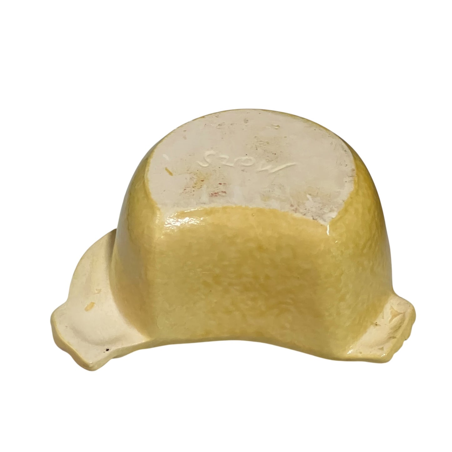 A vintage ceramic bowl with a glossy, domed shape and a small protruding footed rim, shown from a top-down view on a white background. The glaze is a warm, pale yellow with a cream-colored unglazed center on the underside.