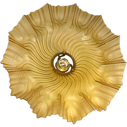 close up of amber coloured vintage French  pendant light with a scalloped design on a white background