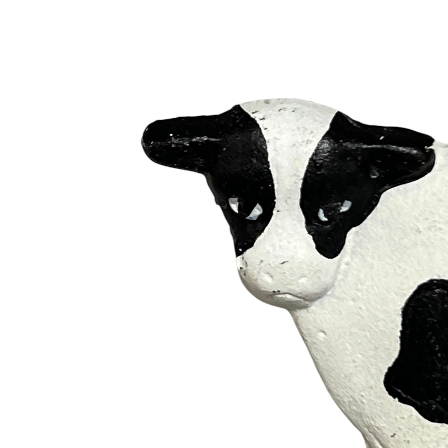 Close-up of a cow toilet roll holder on a white background