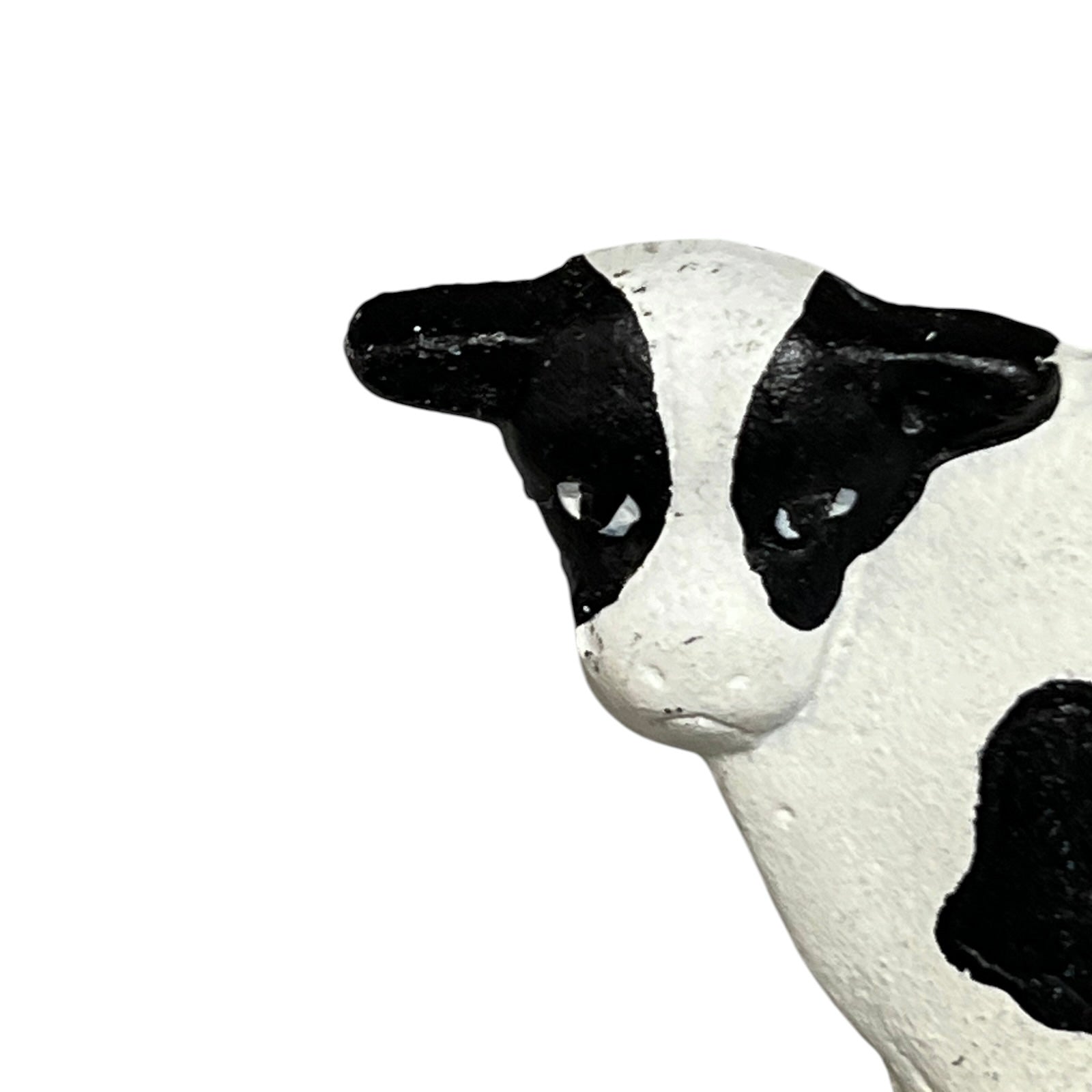Close-up of a cow toilet roll holder on a white background