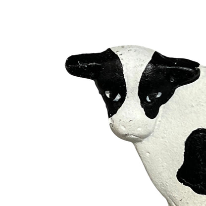 Close-up of a cow toilet roll holder on a white background