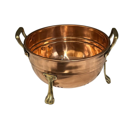 Copper colander with brass handles and feet on a white background