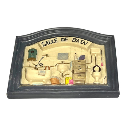 Decorative wall art of a bathroom scene with 'Salle de Bain' text.