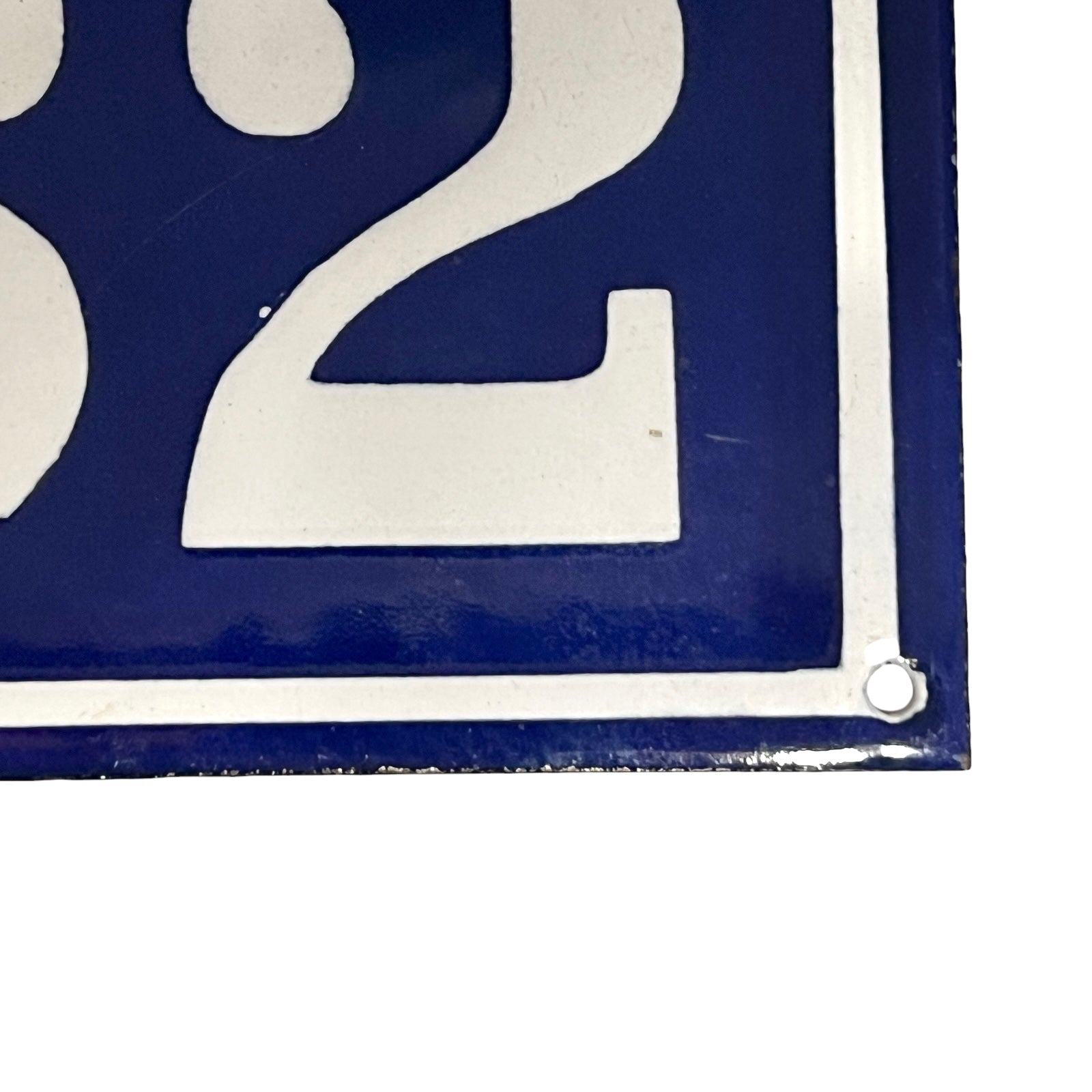 Close-up of a blue and white number '2' sign