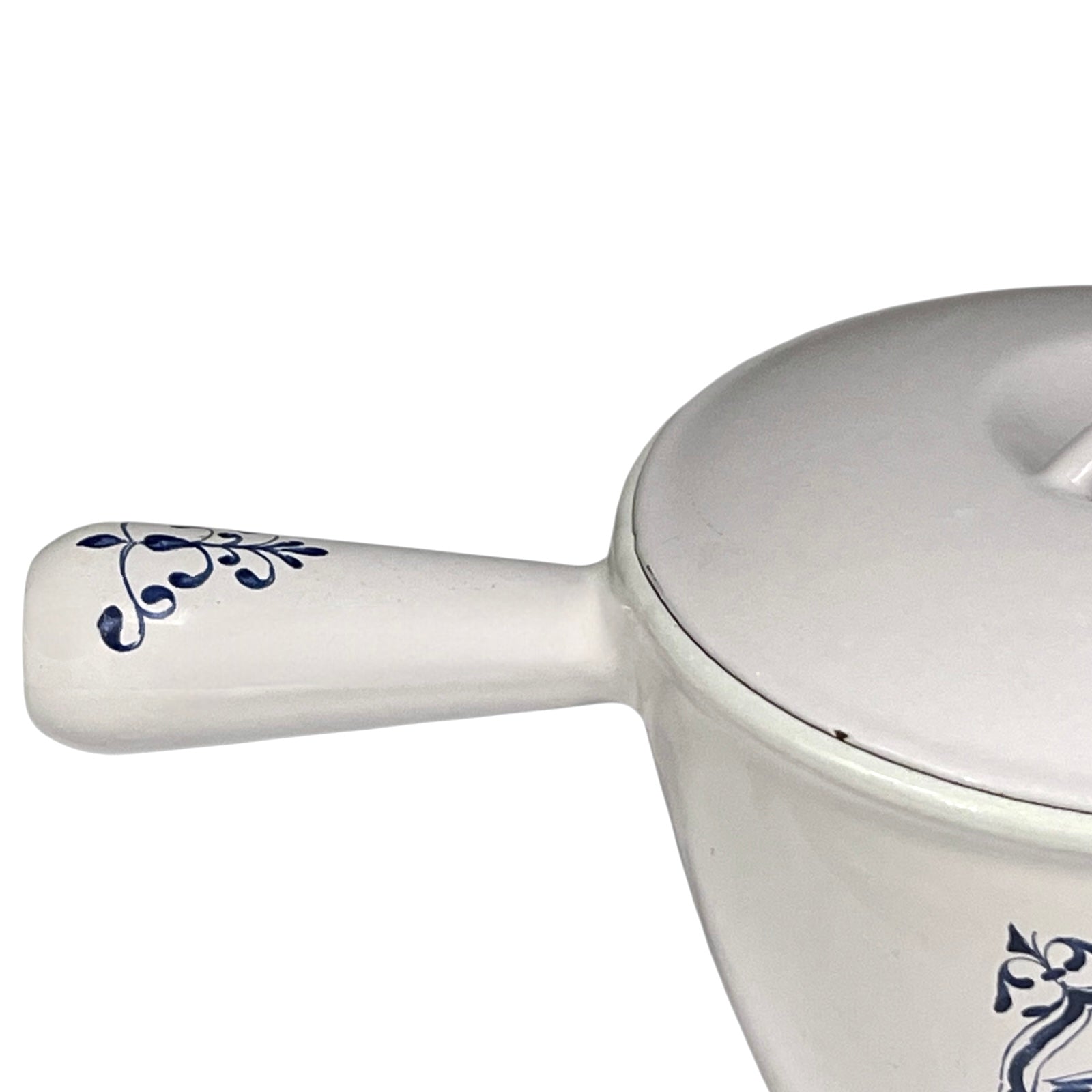 White enamelled cast iron pot with blue floral design and handle on a white background