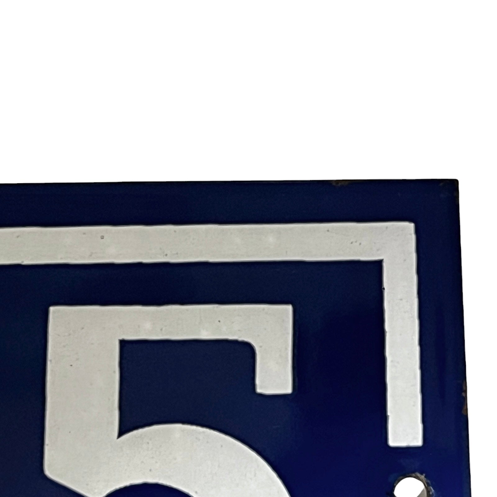 Close up of blue and white door number 65 on a white background 