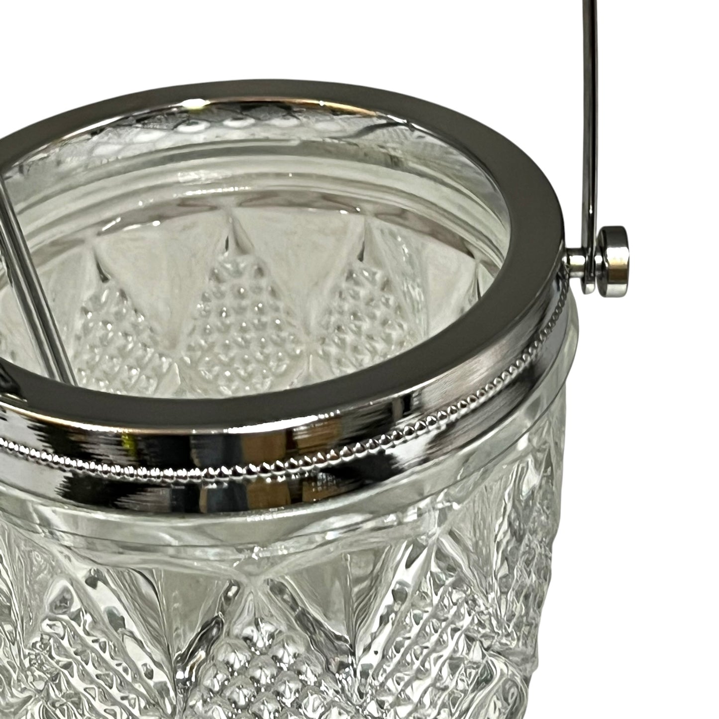 Close-up of a crystal ice bucket with silver lid and handle on a white background