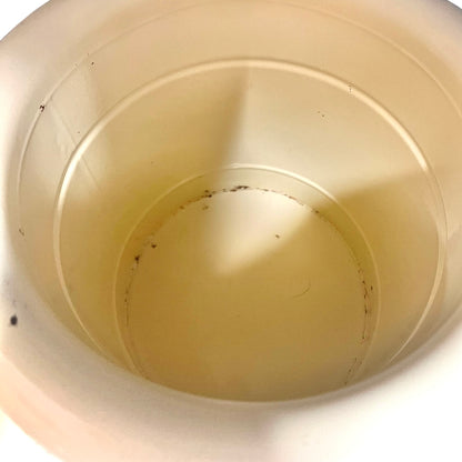 Close up of a French enamel bucket on a white background 