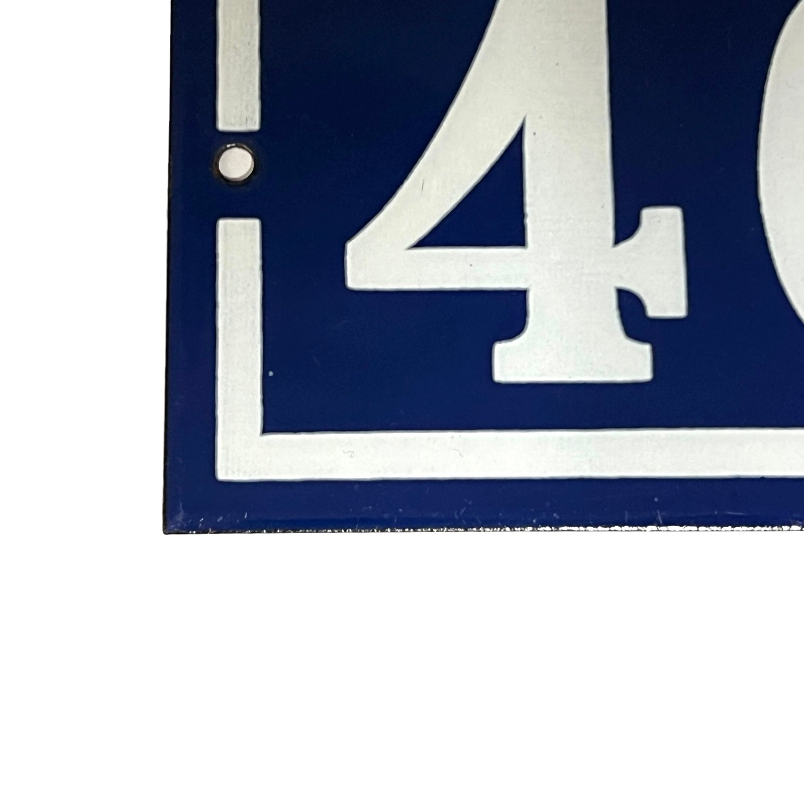 Close up of a French enamel door number on a white background 