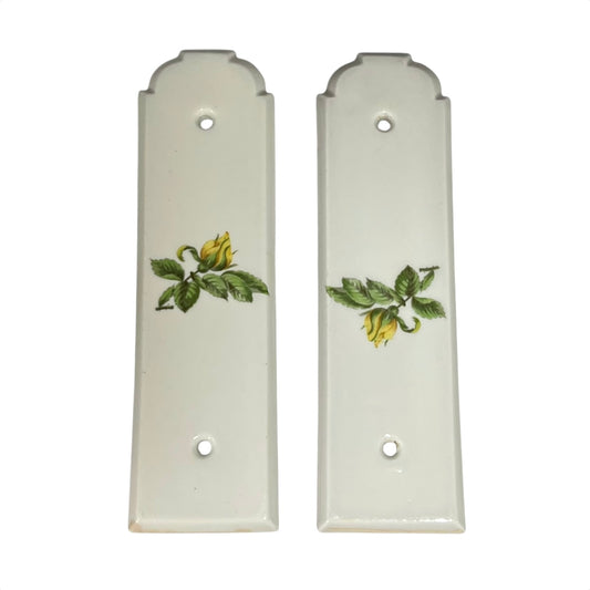 Two ceramic finger plates with floral designs on a white background