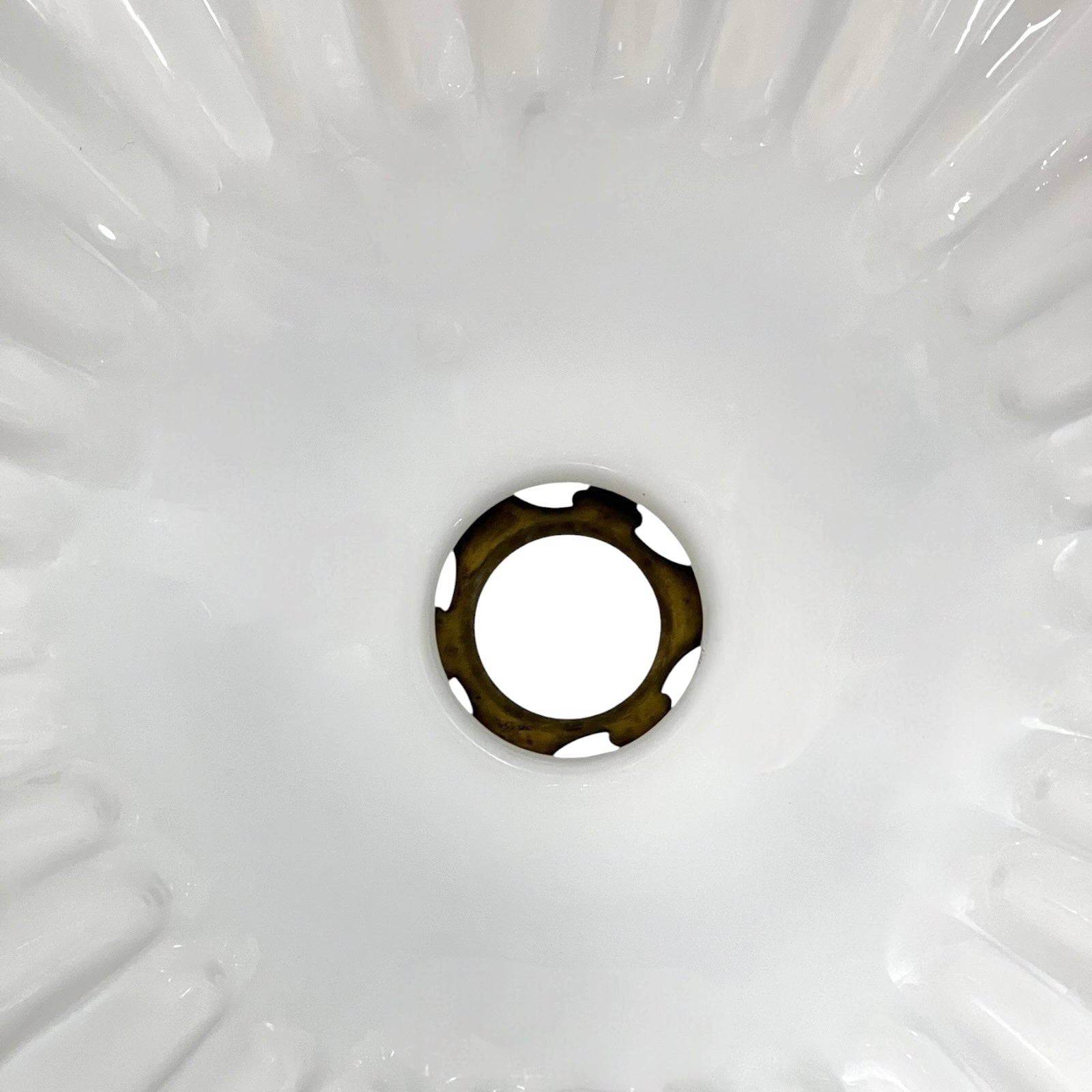 Close-up of a white milk glass lamp shade interior