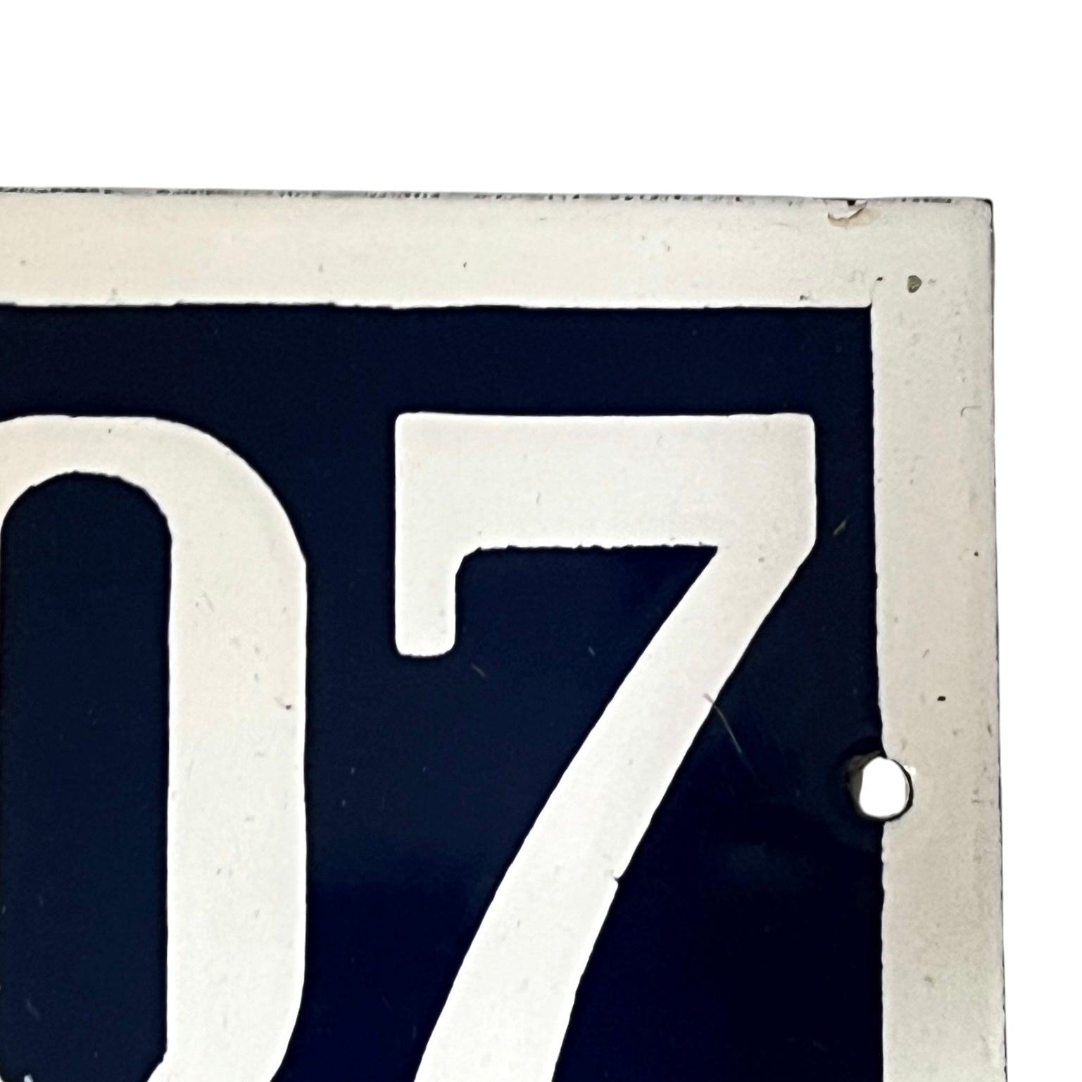Close-up of a number '07' on a dark background with a white border.
