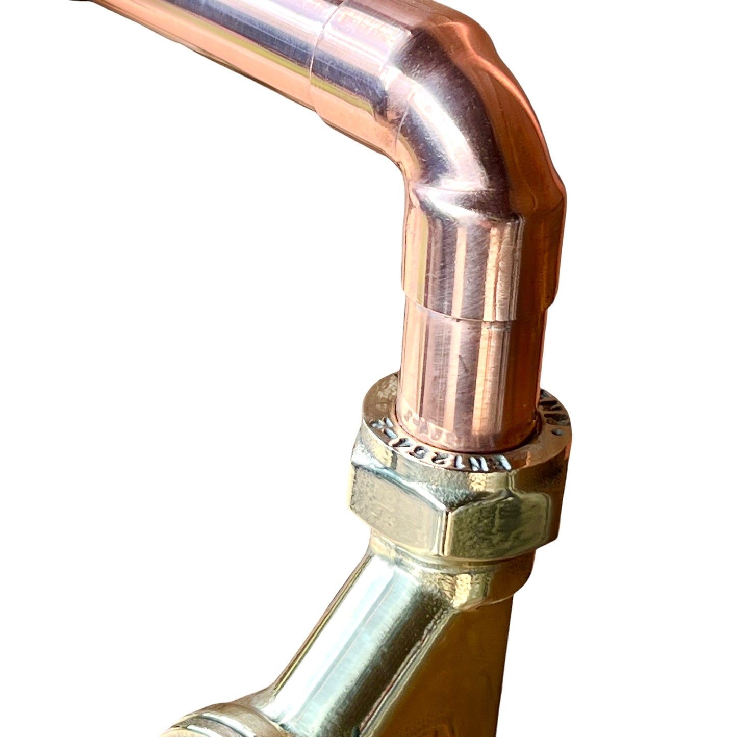 close up of copper and brass tap fitting on a white background 