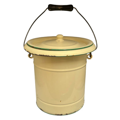 A charming French vintage enamel lidded potty bucket with a wooden handle, featuring a cream finish accented by a green trim. Perfect for use in a farmhouse kitchen as a vegetable or bread bin, or repurposed as a unique garden planter, displayed against a crisp white background.