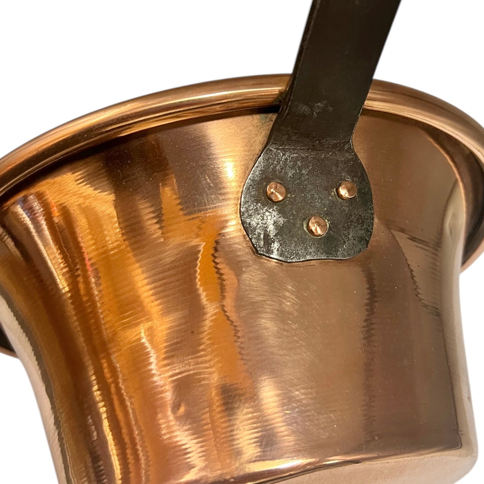 Close up of French vintage copper ladle pan with a black handle on a white background