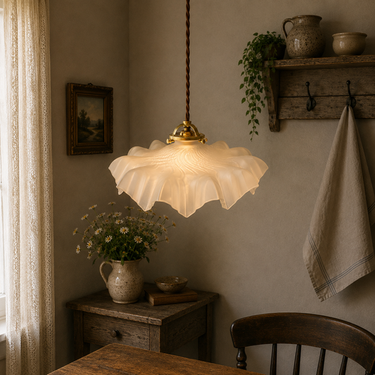 A French vintage frosted clear glass lampshade with a charming frilled edge, featuring a brass collar, bulb holder, and vintage-style twisted wiring. Perfect for adding a touch of period elegance to any vintage-inspired home decor, set hanging from a ceiling in a farmhouse country setting