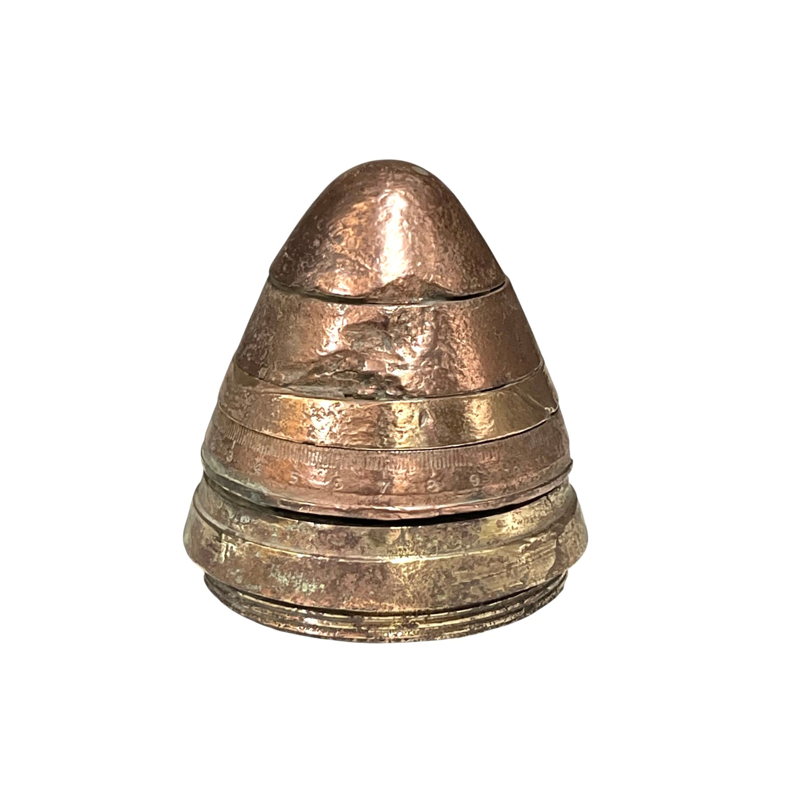 WW1 brass fuse now repurposed as a paperweight, with markings for identification of wear, on a white background