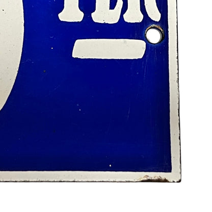 Close-up of a blue and white sign  on a white background