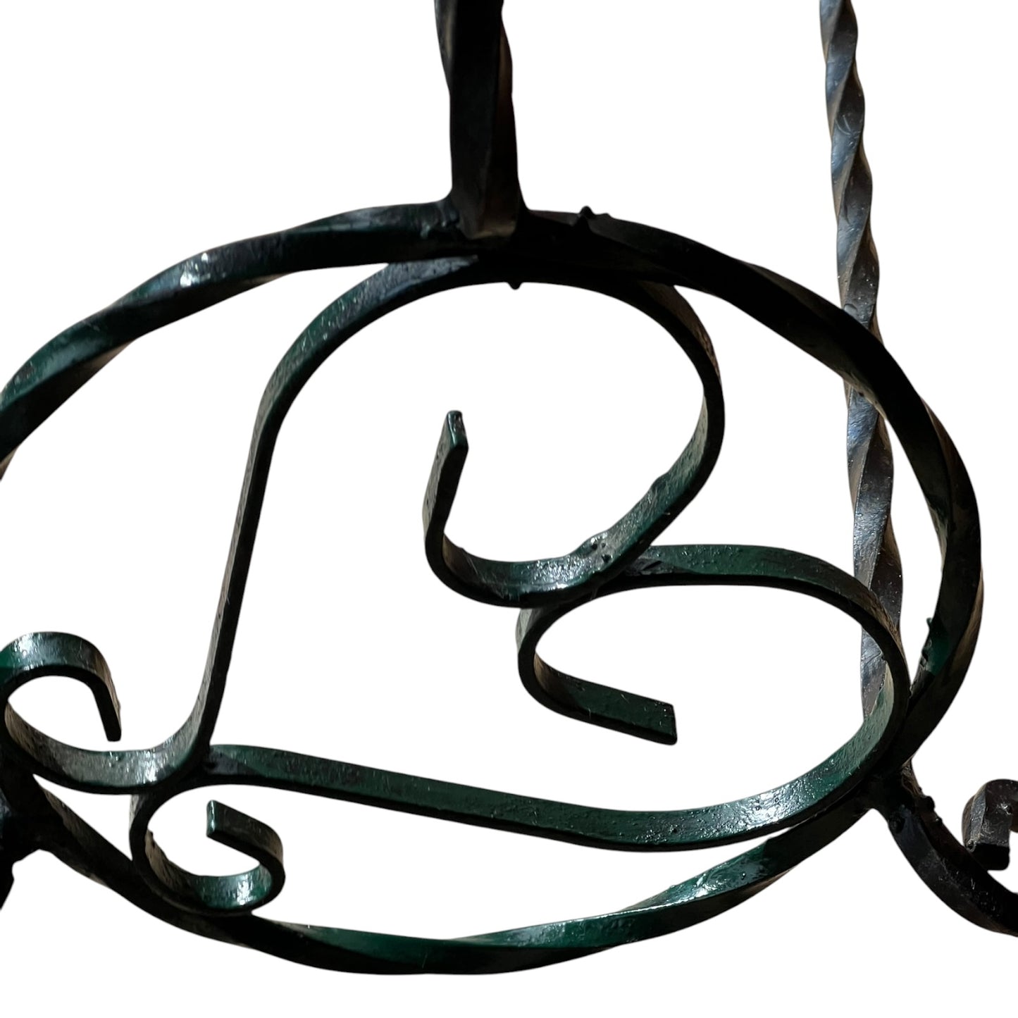 Close up of a wrought iron vintage plant stand on a white background 