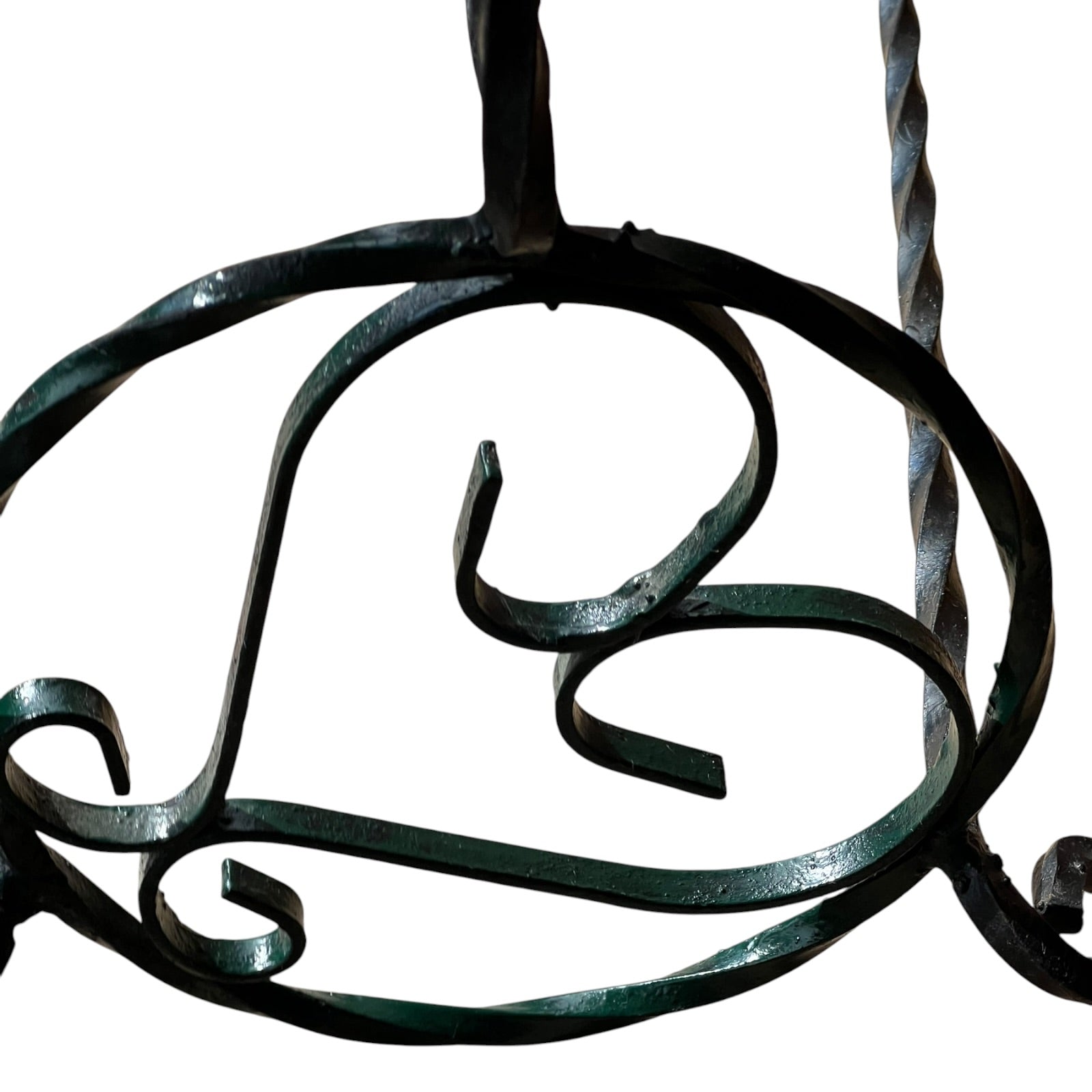 Close up of a wrought iron vintage plant stand on a white background 