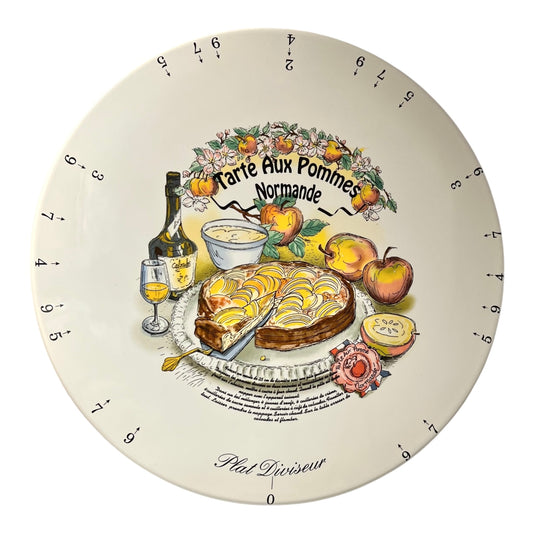 Decorative serving platter with a design of a tart and apples on a white background