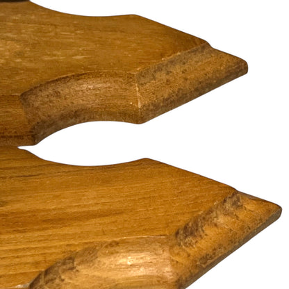 Close up of deer hoof hooks on wooden mounts on a white background