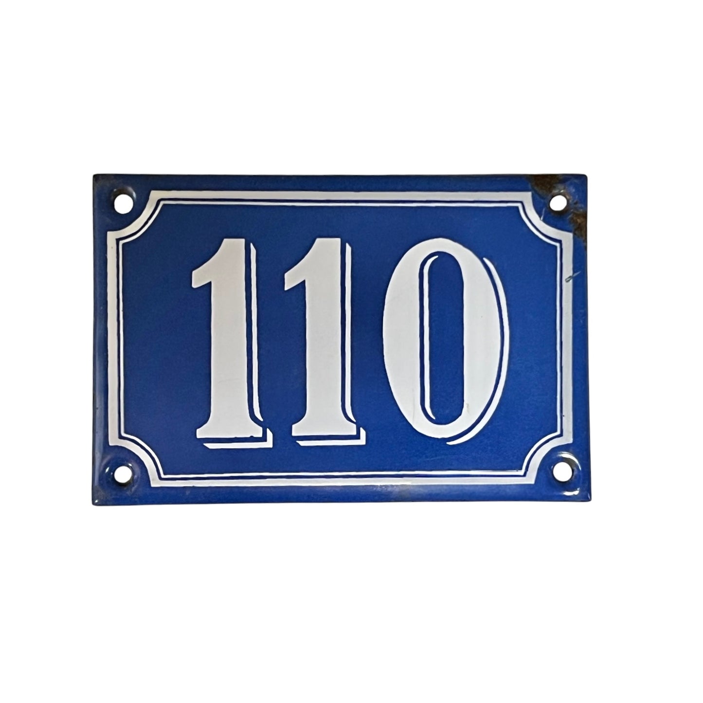 Blue house number plate with white text '110' on a white background