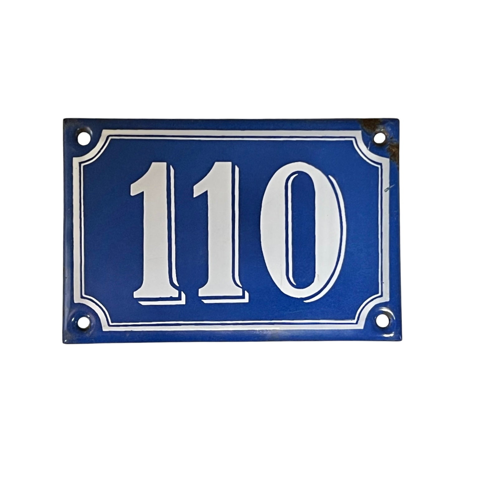 Blue house number plate with white text '110' on a white background