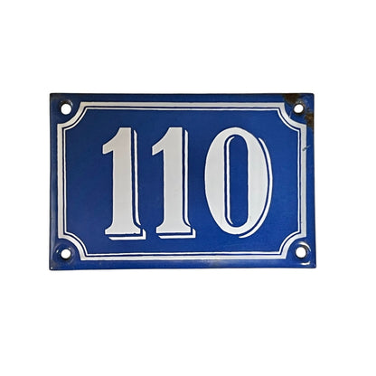 Blue house number plate with white text '110' on a white background