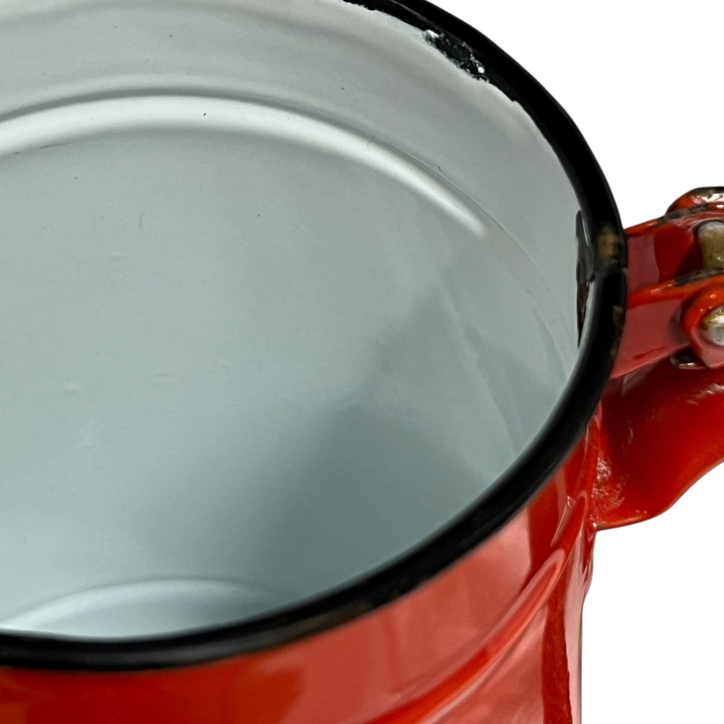 Close up of a red vintage French enamelled coffee pot on a white background