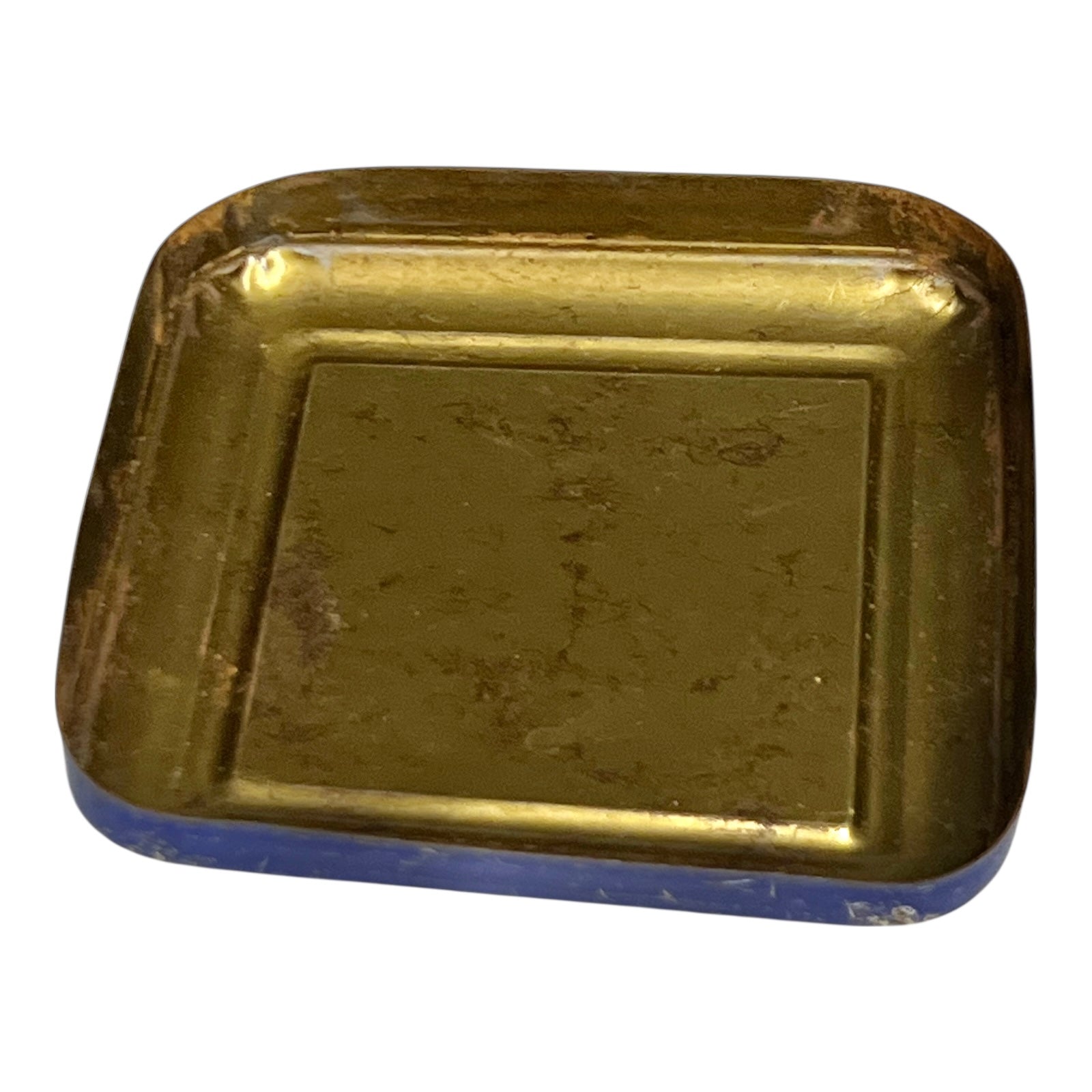 Gold-colored rectangular object with blue base on a white background