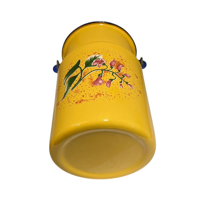 A yellow enamel churn with a floral design of pink flowers and green leaves on the side, shown against a plain white background.