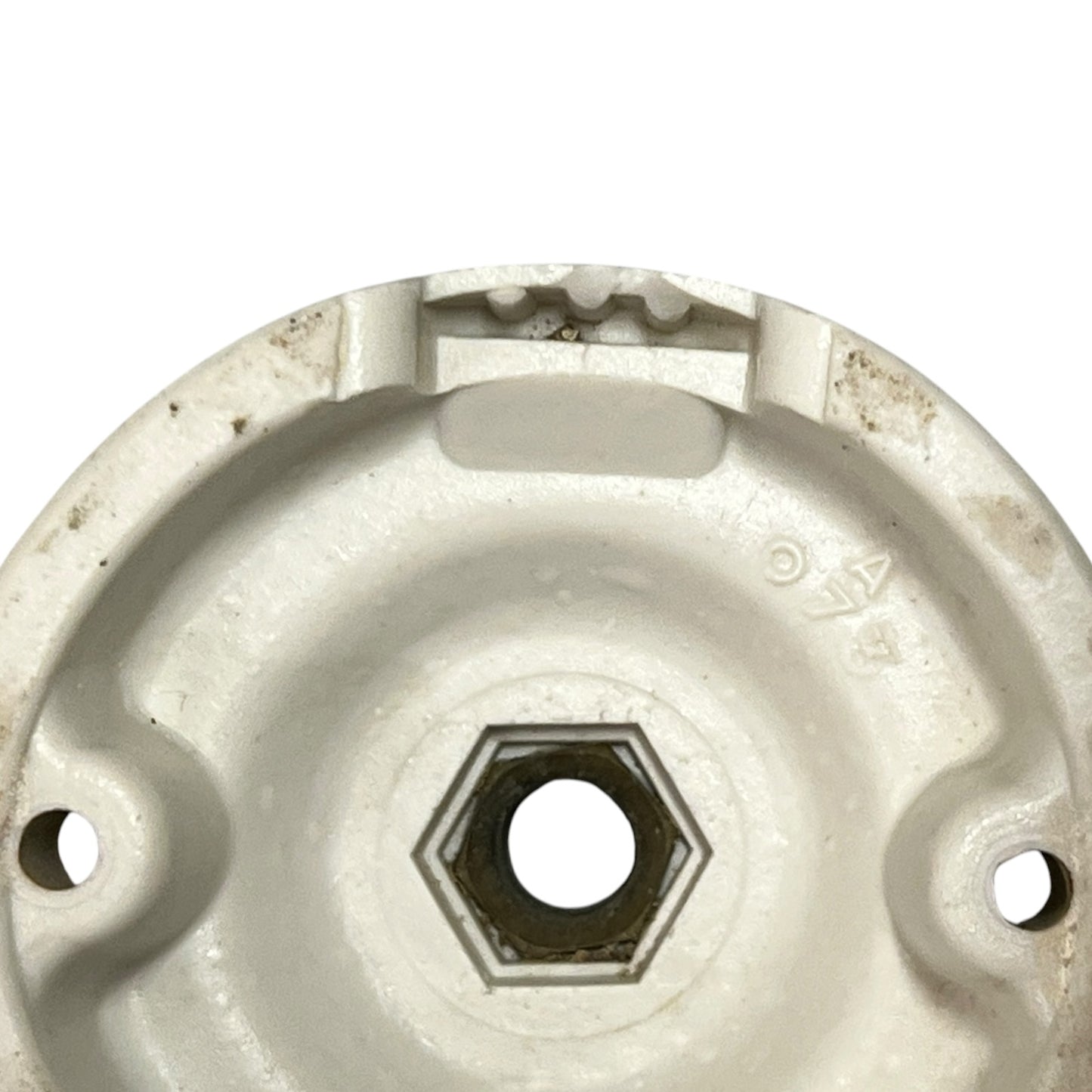 Small vintage French porcelain ceiling rose with a brass nut on a white background 