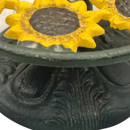 Decorative rustic paper towel holder with yellow sunflower designs on a black background