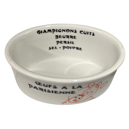 White ceramic ramekin with black text and red design on a white background