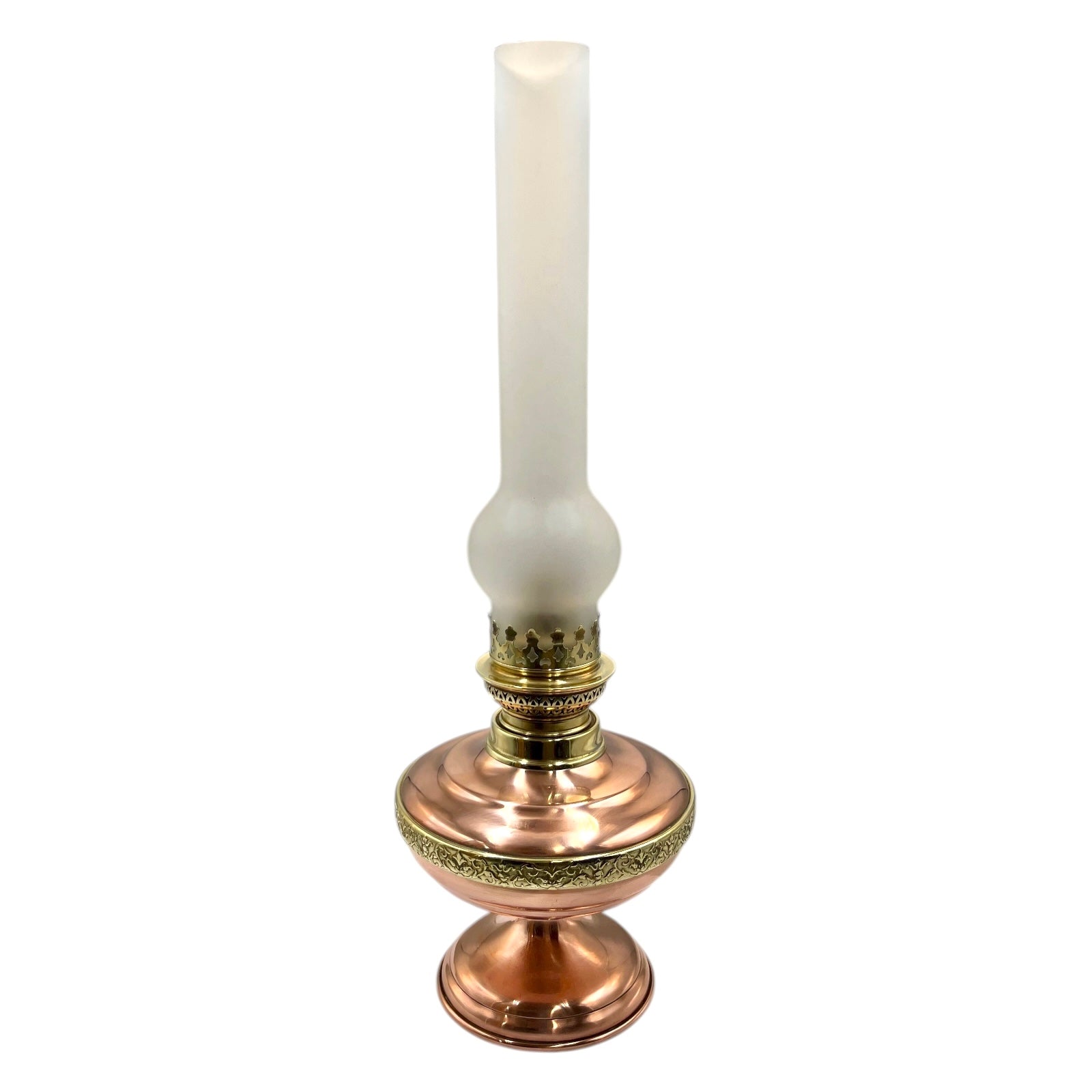 Decorative copper and brass oil lamp with a frosted chimney on a white background