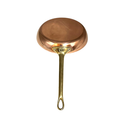 A small copper frying pan with a long, slender brass handle, shown from a top-down view on a solid white background.