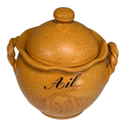 Brown ceramic jar with lid and handles on a white background