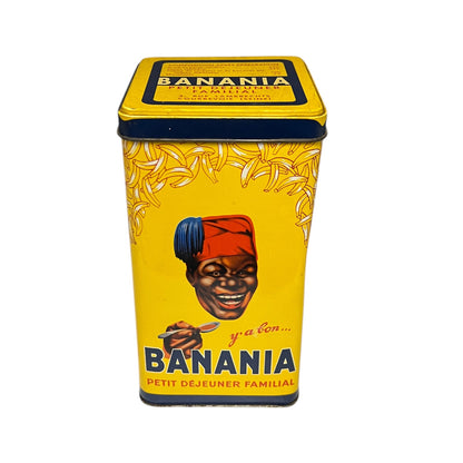 Vintage-style 'Banania' breakfast cereal tin with a colorful label featuring a person holding a spoon.