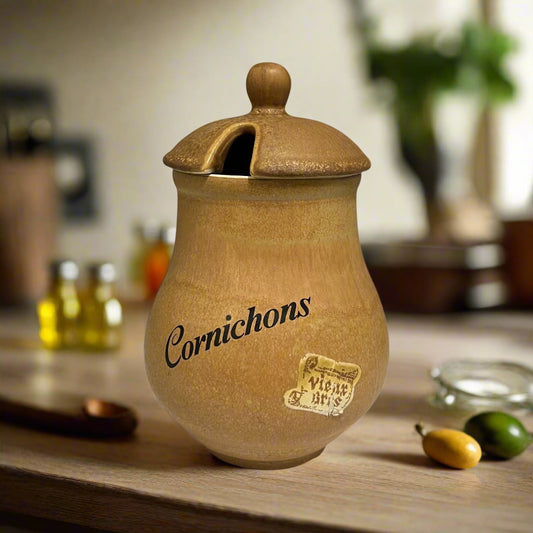 Stoneware jar with a lid labelled 'Cornichons' in a rustic kitchen for sale from All Things French Store